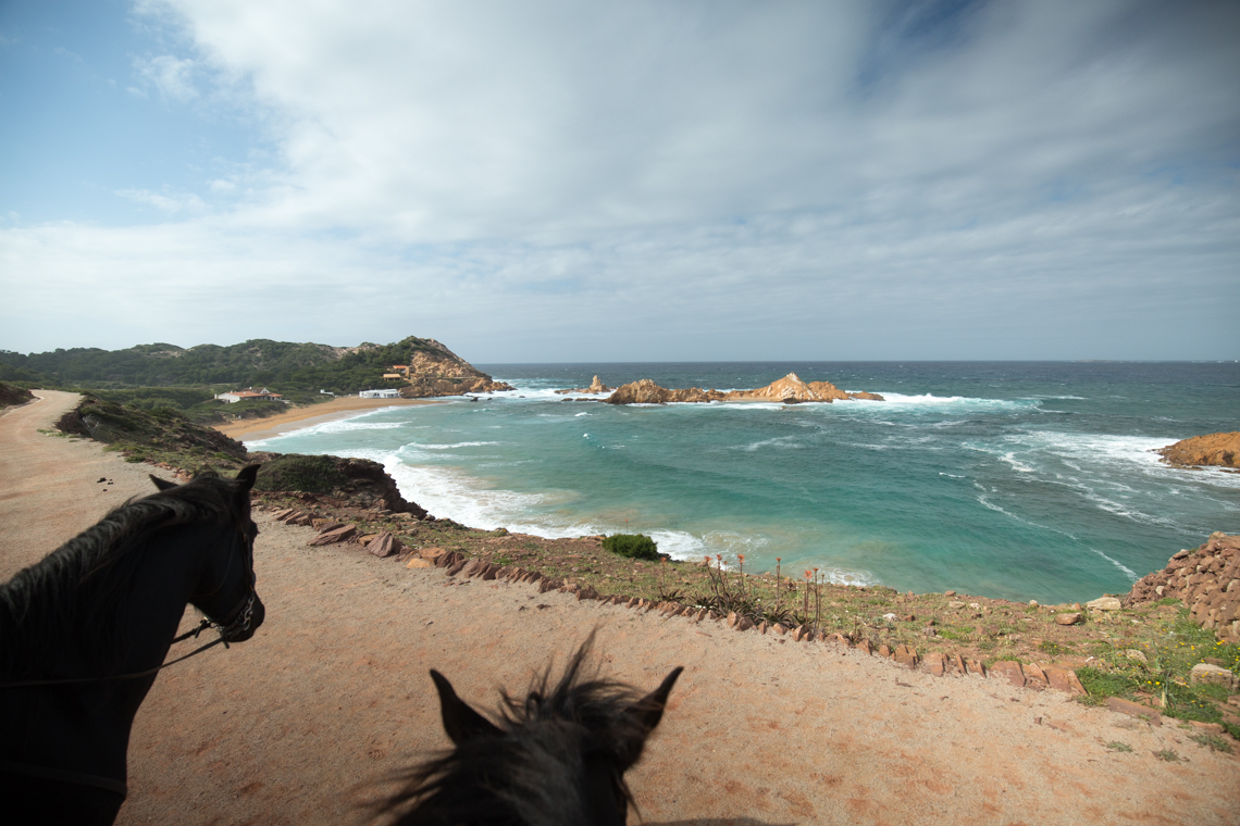 View of coastline horse riding