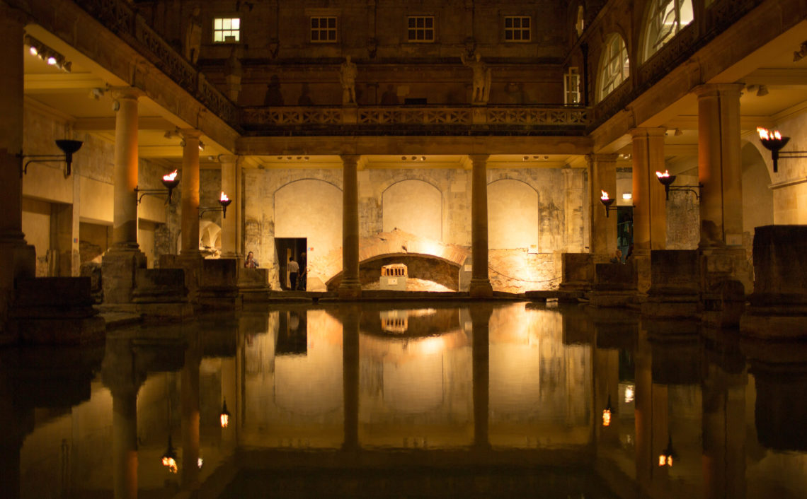 Looking across the water at the Roman Baths at night
