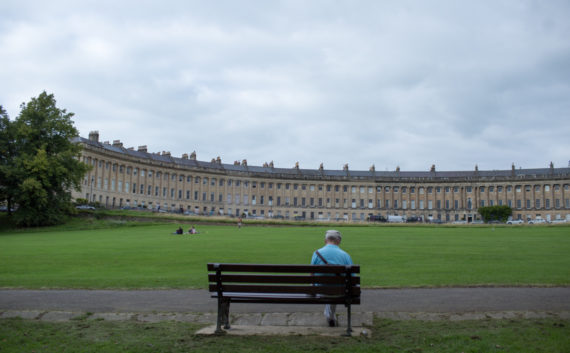 Man sat on a bench at Royal Crescent Bath